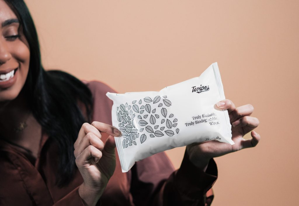 A photo of a woman holding pack of Twipes