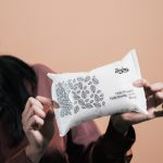 A photo of a woman holding pack of Twipes