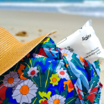 A photo of a beach hat, a flowery blue bag and a pack of Twipes on the beach (Twipes team photo)
