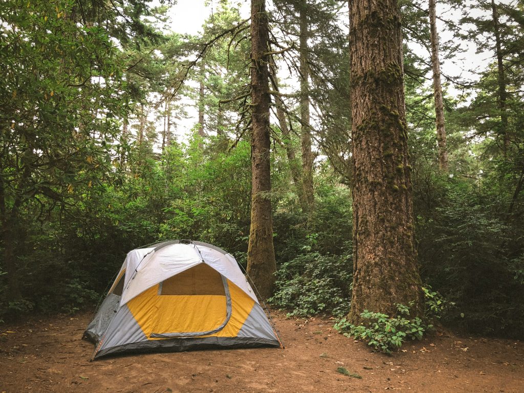 A photo of a tent in the woods.